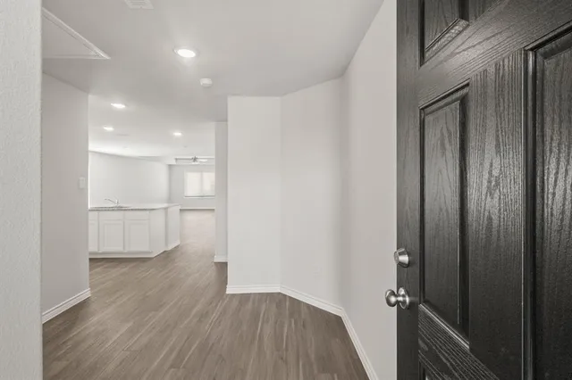 a view of a hallway with wooden floor