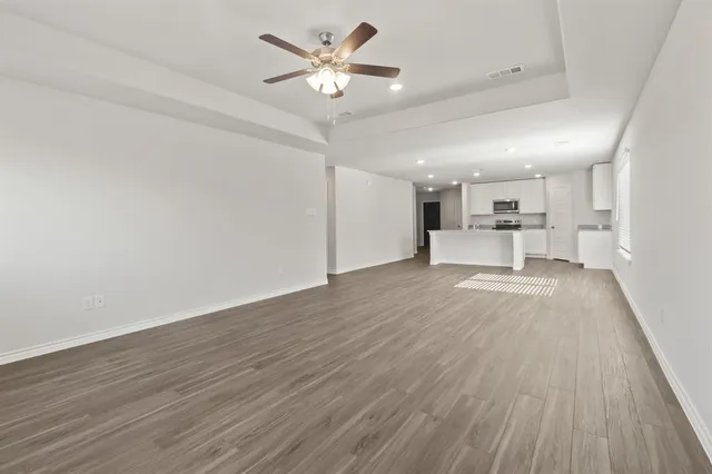 a view of kitchen with cabinets and wooden floor