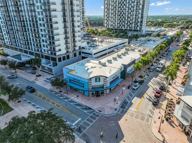 an aerial view of a multi story parking building with yard