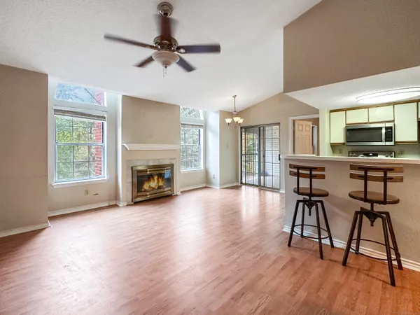 a view of a livingroom with furniture and a kitchen