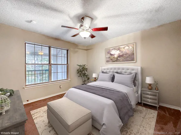 a bedroom with a large bed and a window