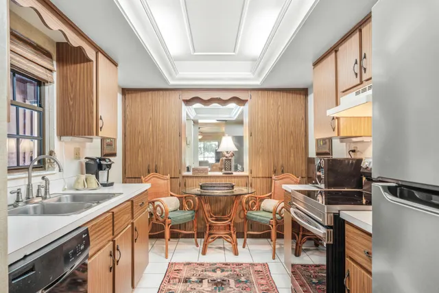 a kitchen with a sink cabinets and a window