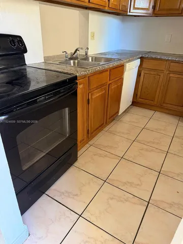 a stove top oven sitting inside of a kitchen