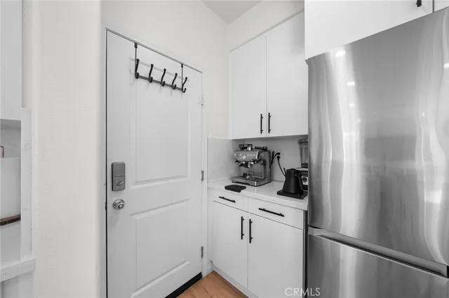 a view of a refrigerator and washer in a kitchen