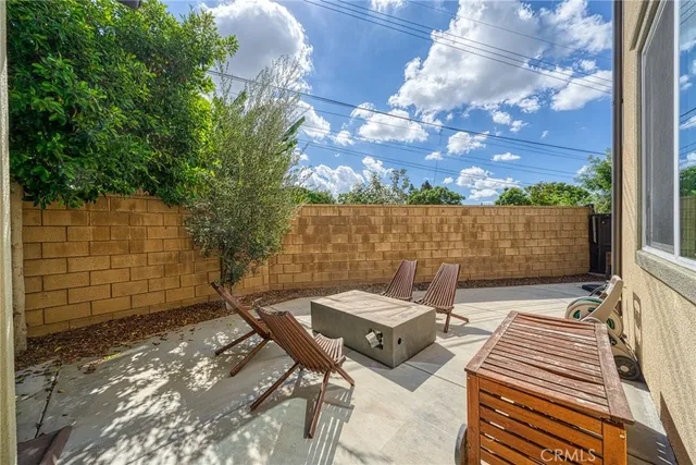a view of a patio with table and chairs with wooden floor and fence