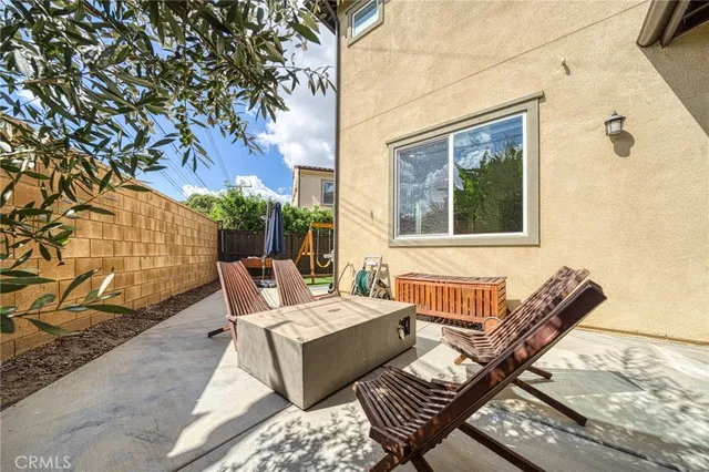 a backyard of a house with table and chairs