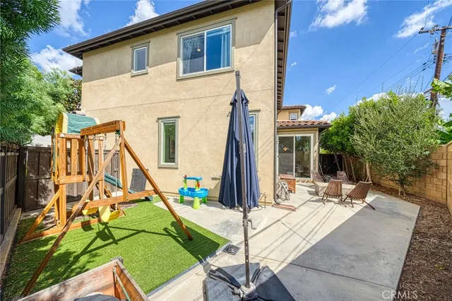 a view of house with yard and staircase