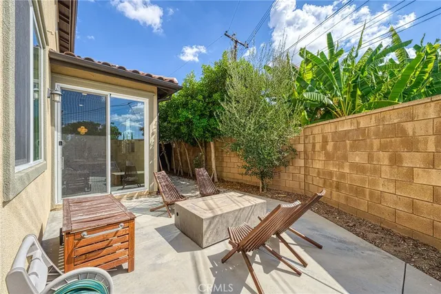 a view of a patio with a table and chairs and potted plants