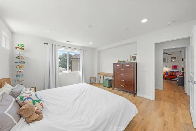 a bedroom with a bed and a dresser