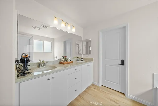 a bathroom with a double vanity sink and a mirror