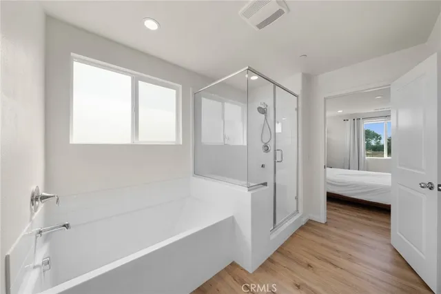 a bathroom with a tub shower and sink