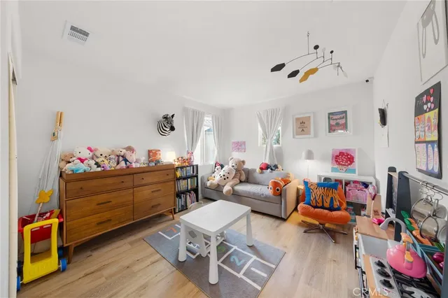 a bed room with furniture and wooden floor