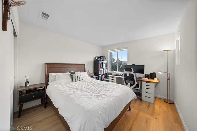 a bedroom with a bed a table and chair