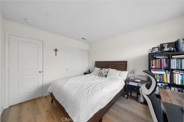 a bedroom with a bed and a book shelf