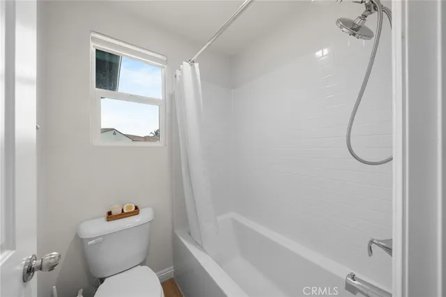 a bathroom with a toilet and a bathtub