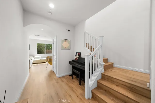 a view of entryway and hall with wooden floor