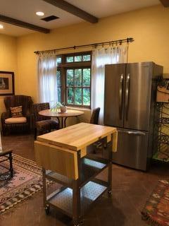 0 East Valley Road Montecito, CA 93108 - Photo 3 of 10 a kitchen with stainless steel appliances granite countertop a refrigerator a stove a sink a dining table and chairs with wooden floor