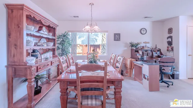 a view of a dining room with furniture and chandelier