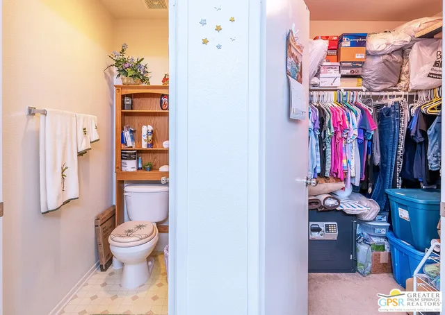 a bathroom with a toilet and a shower curtain