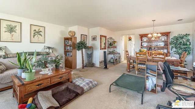 a living room with furniture and a chandelier