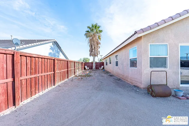 a view of a house with backyard and deck