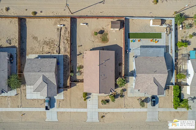 an aerial view of a house with a street