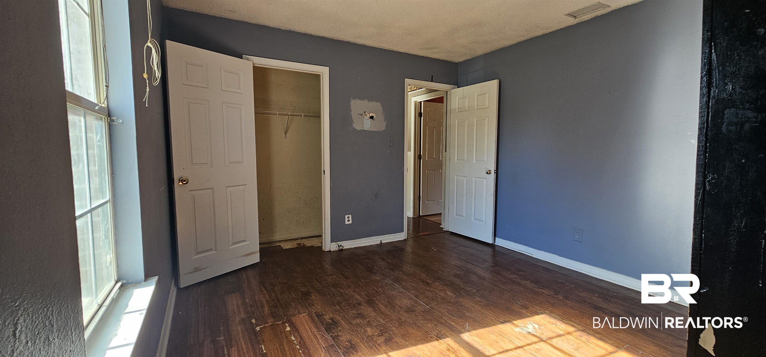 151 Bullard Street Atmore, AL 36502 - Photo 17 of 38 Unfurnished bedroom with wood finished floors and a closet
