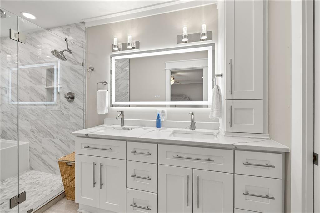 6470 Samoa Way Flowery Branch, GA 30542 - Photo 40 of 61 a bathroom with a granite countertop sink mirror and