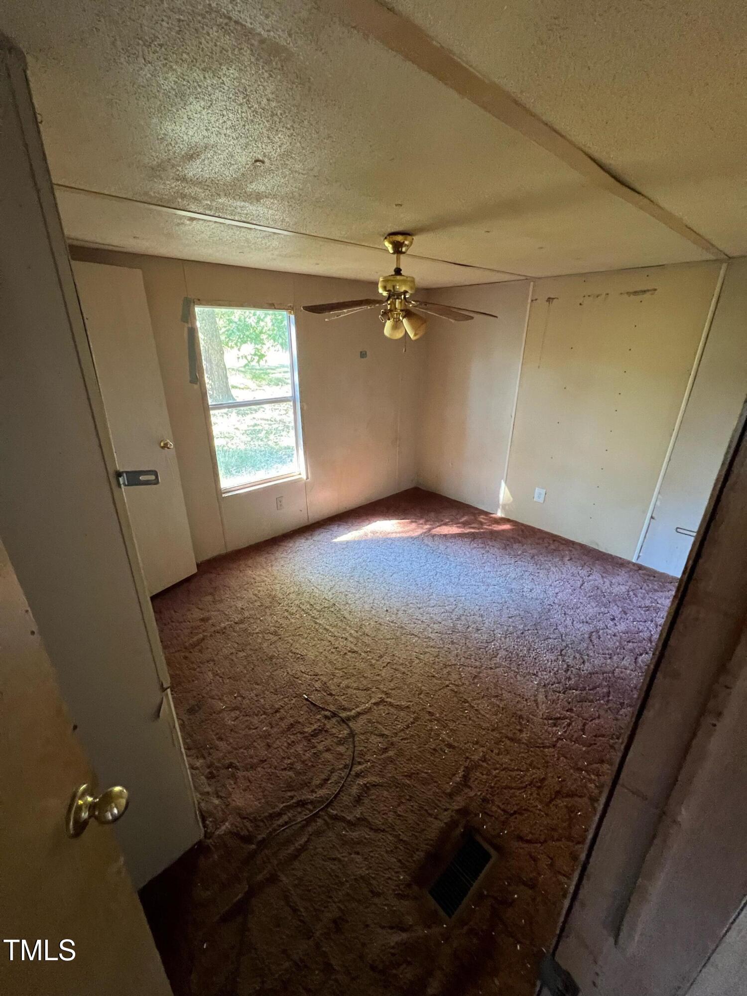 377 Mellie Clayton Road Roxboro, NC 27574 - Photo 4 of 14 a view of an empty room and a window