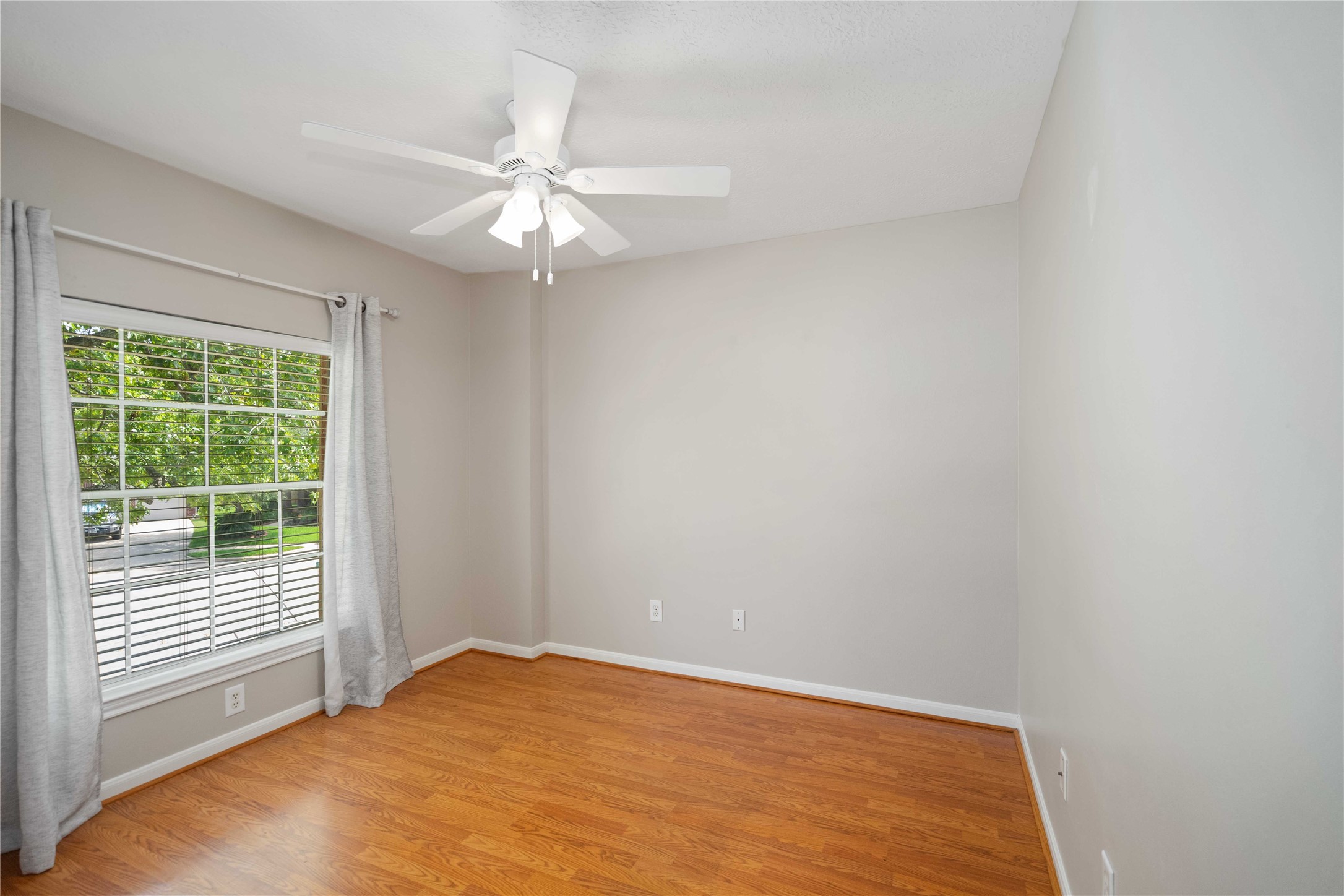 707 Lytton Springs Way Spring, TX 77373 - Photo 25 of 27 an empty room with a window and a fan