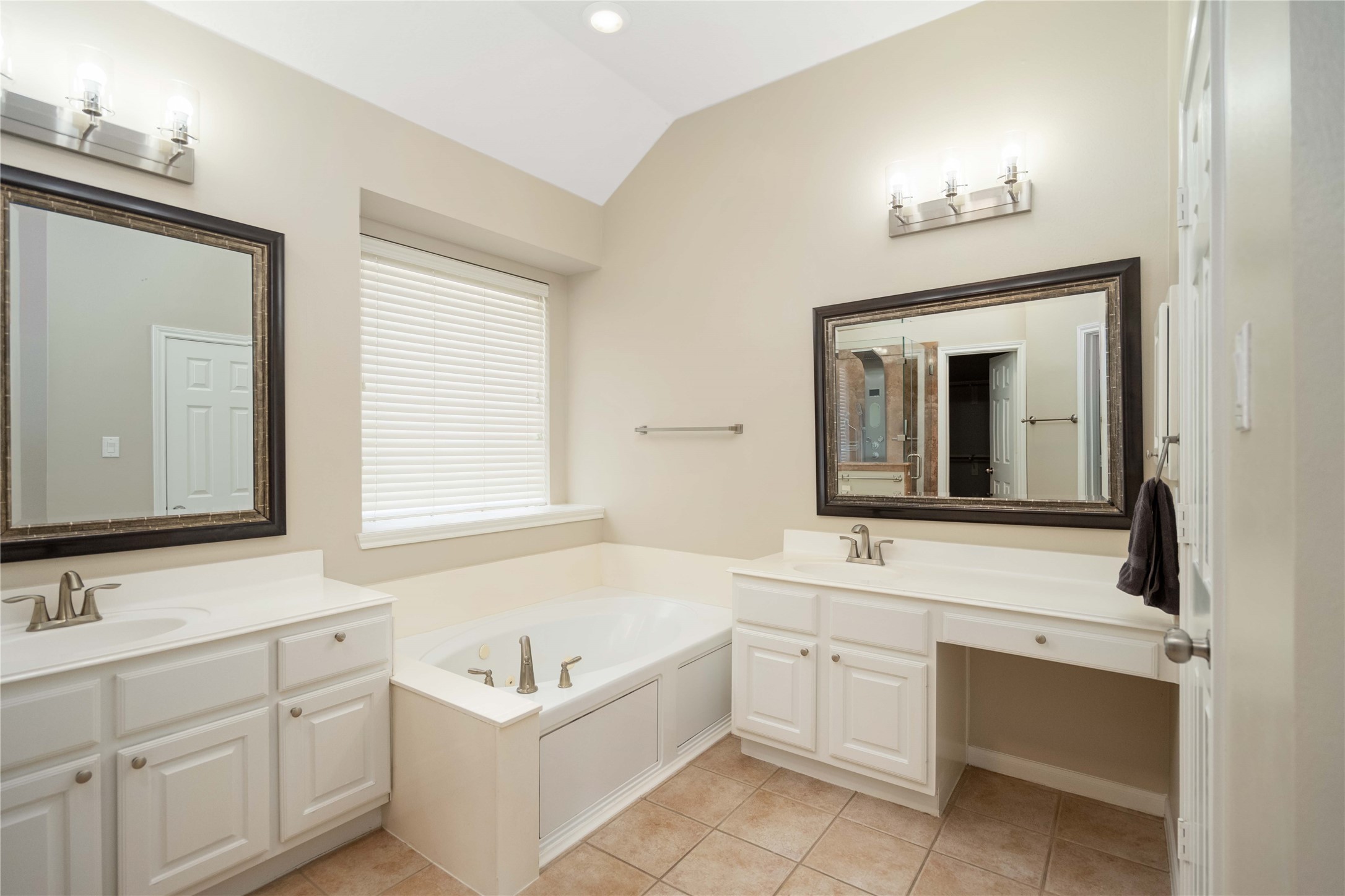 707 Lytton Springs Way Spring, TX 77373 - Photo 3 of 27 a bathroom with a sink vanity tub and a mirror