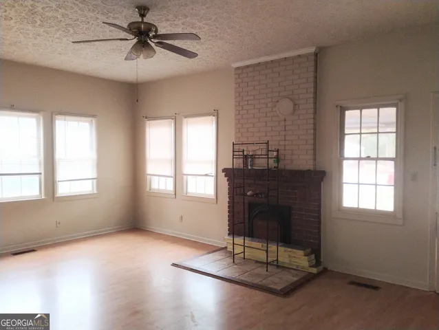 a living room with a table chairs and a fireplace