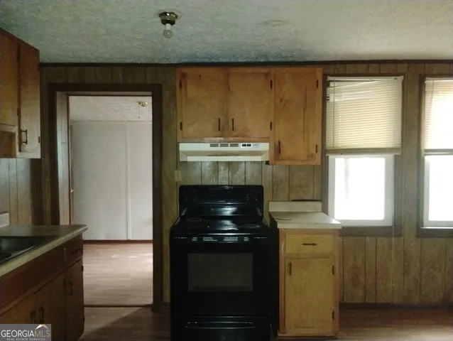 a kitchen with a stove and a microwave