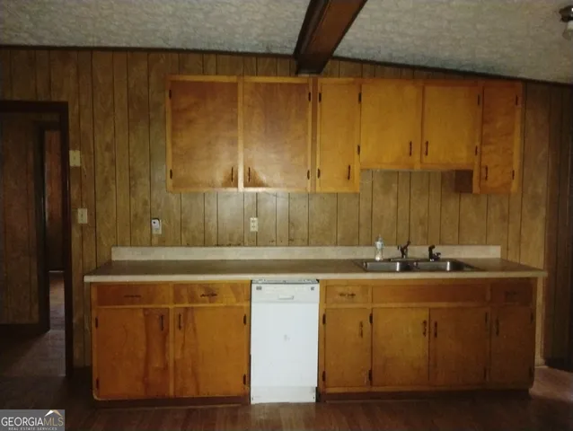 a room with a sink and cabinets