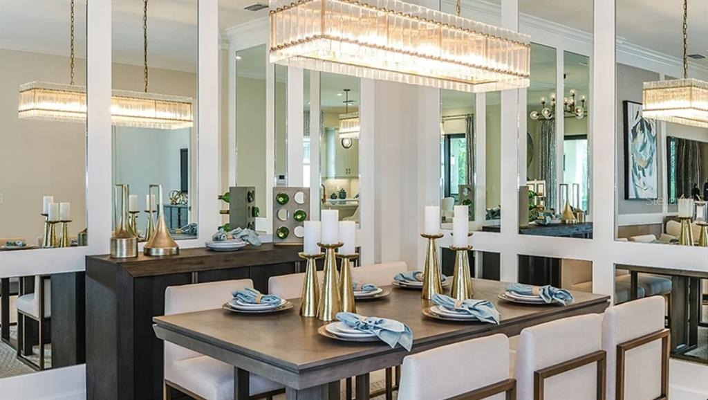 14923 Contenta Loop Bradenton, FL 34211 - Photo 9 of 31 a view of a dining room with furniture large windows and wooden floor