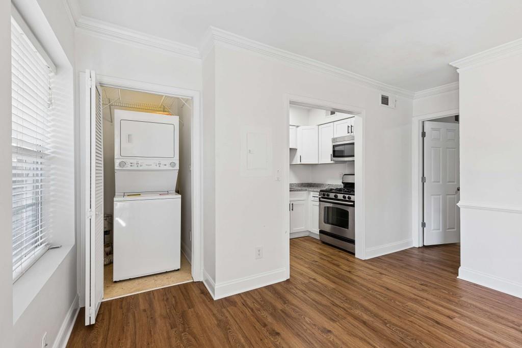 6980 Roswell Road, Unit C13 Atlanta, GA 30328 - Photo 11 of 49 a kitchen with wooden floors and white appliances