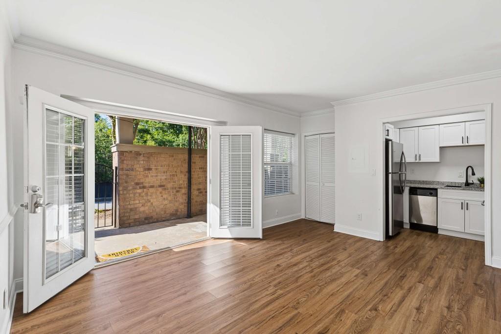 6980 Roswell Road, Unit C13 Atlanta, GA 30328 - Photo 14 of 49 a view of empty room with wooden floor and fan