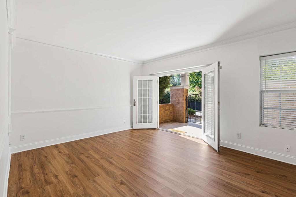 6980 Roswell Road, Unit C13 Atlanta, GA 30328 - Photo 15 of 49 an empty room with wooden floor and windows