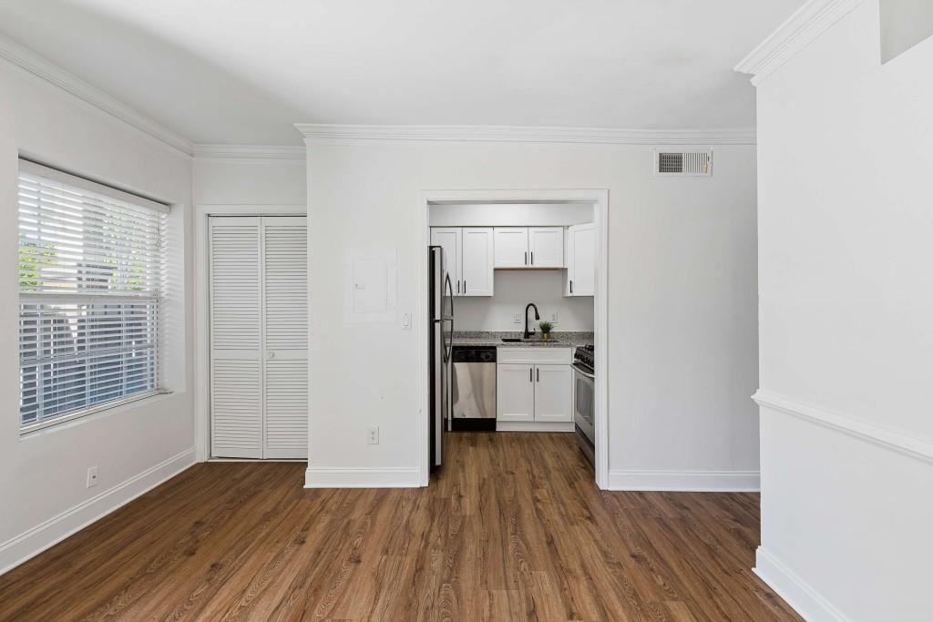 6980 Roswell Road, Unit C13 Atlanta, GA 30328 - Photo 18 of 49 a kitchen with wooden floors and white appliances