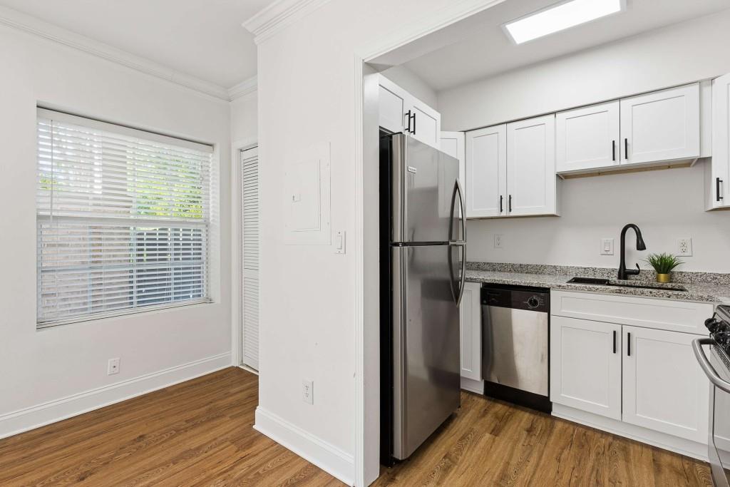 6980 Roswell Road, Unit C13 Atlanta, GA 30328 - Photo 20 of 49 a kitchen with stainless steel appliances granite countertop a refrigerator and a sink