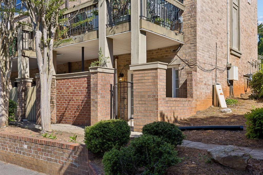 6980 Roswell Road, Unit C13 Atlanta, GA 30328 - Photo 2 of 49 a front view of a house with a yard