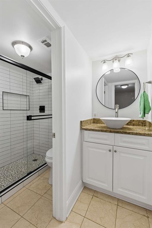 6980 Roswell Road, Unit C13 Atlanta, GA 30328 - Photo 39 of 49 a bathroom with a granite countertop sink a mirror and shower