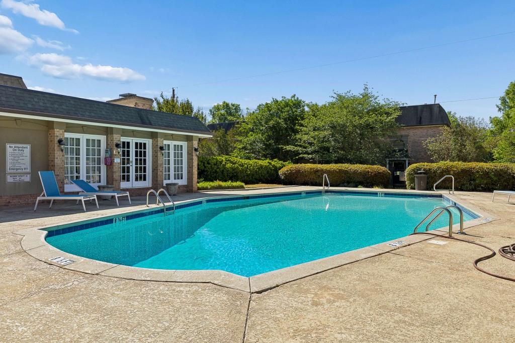 6980 Roswell Road, Unit C13 Atlanta, GA 30328 - Photo 47 of 49 a view of pool with lawn chairs and plants