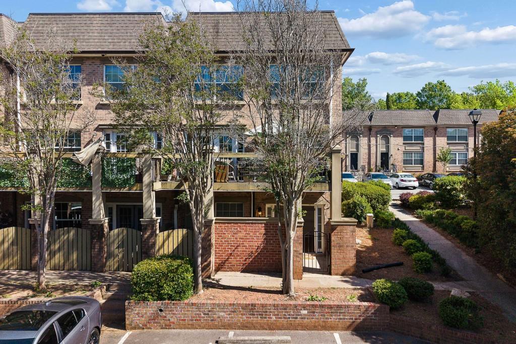 6980 Roswell Road, Unit C13 Atlanta, GA 30328 - Photo 7 of 49 front view of a building with a garden