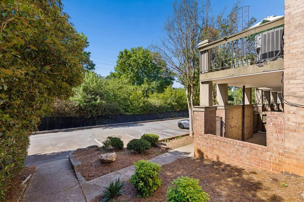 6980 Roswell Road, Unit C13 Atlanta, GA 30328 - Photo 8 of 49 a view of backyard with large tree and wooden fence