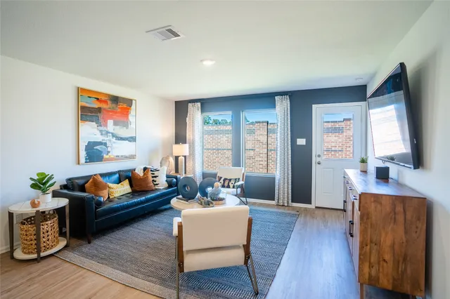 a living room with furniture and a large window