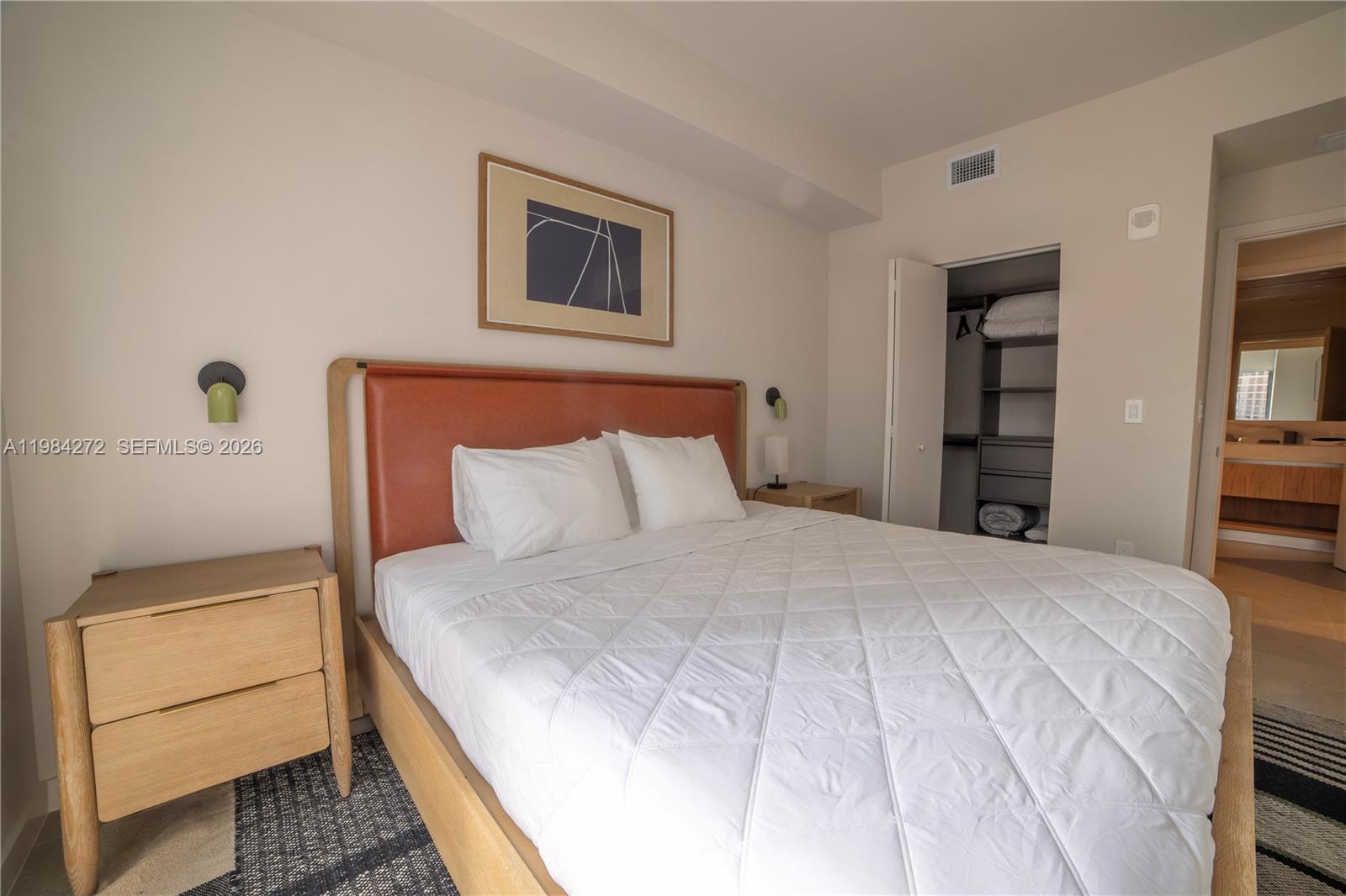 11 Northeast 6th Street, Unit 1403 Miami, FL 33132 - Photo 11 of 44 a bedroom with a bed and a window