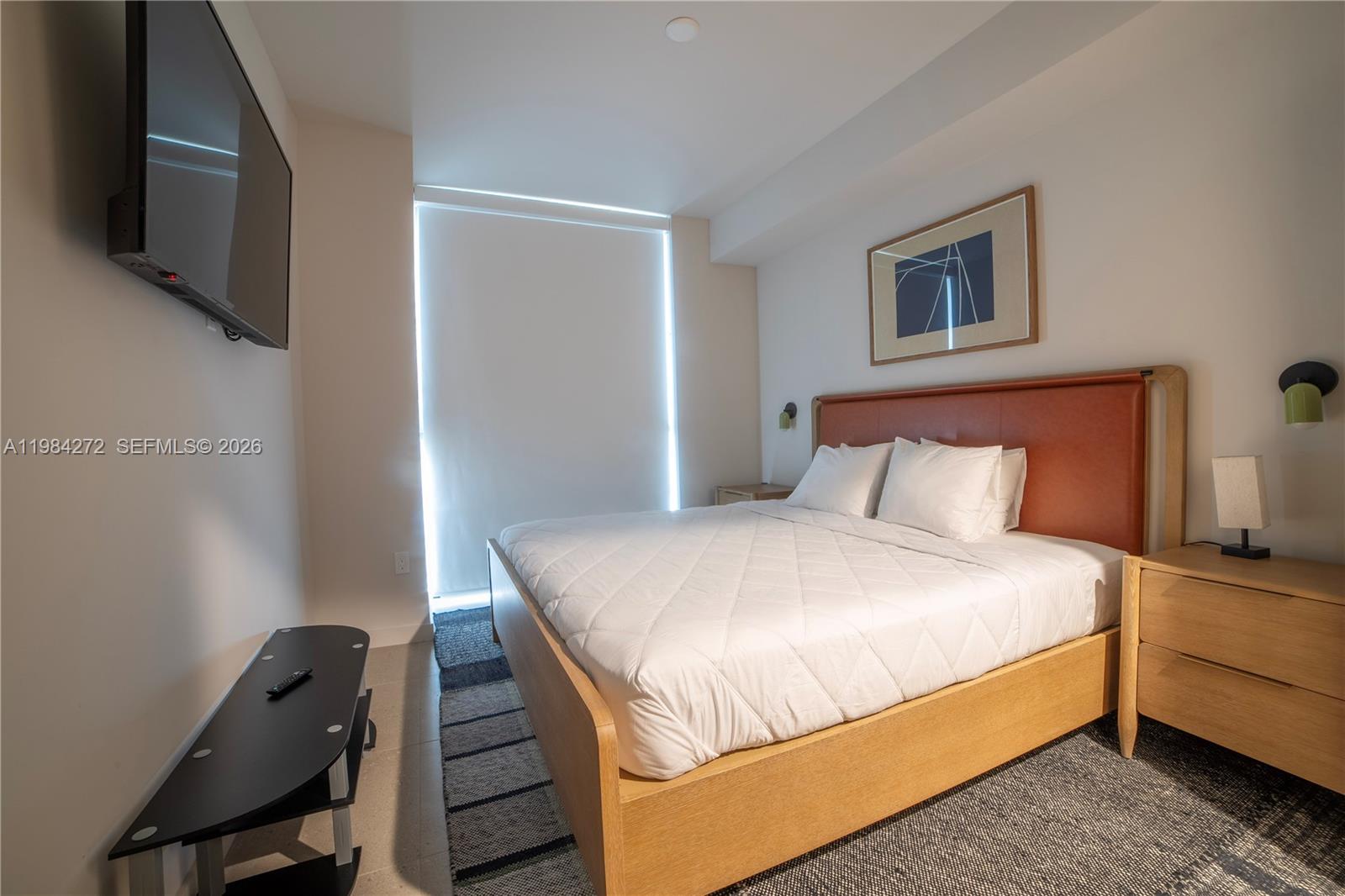 11 Northeast 6th Street, Unit 1403 Miami, FL 33132 - Photo 12 of 44 a bedroom with a bed and a flat screen tv