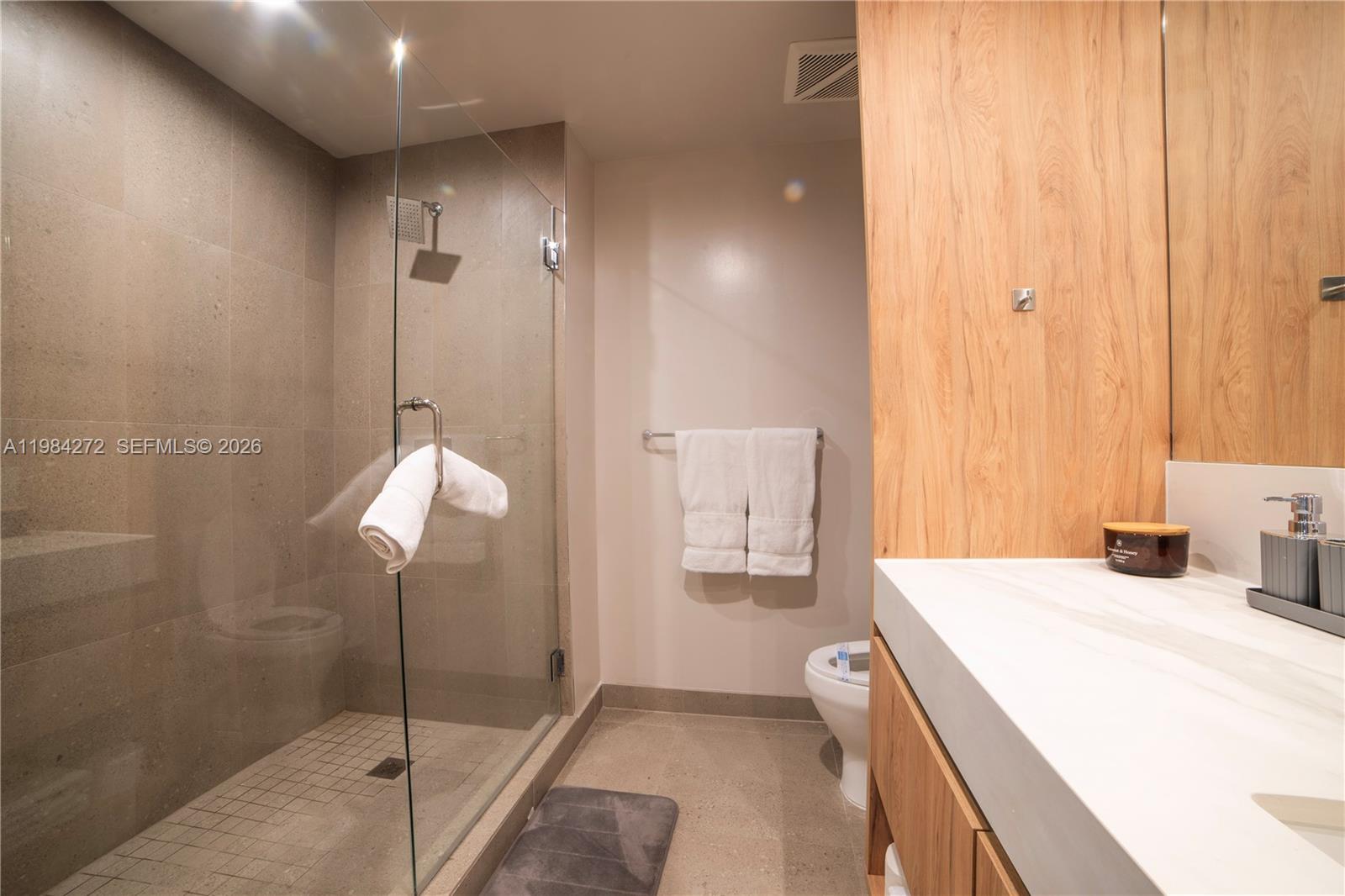 11 Northeast 6th Street, Unit 1403 Miami, FL 33132 - Photo 16 of 44 a en suite bathroom with a sink a mirror and a shower
