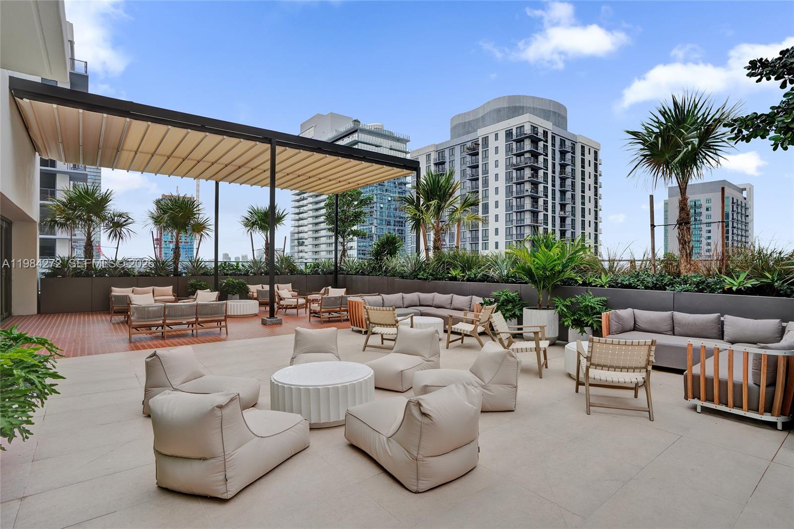 11 Northeast 6th Street, Unit 1403 Miami, FL 33132 - Photo 41 of 44 a view of a patio with couches and potted plants